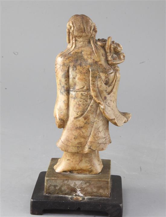 A Chinese creamy soapstone figure of He Xiangu, 19th century, 23cm high
